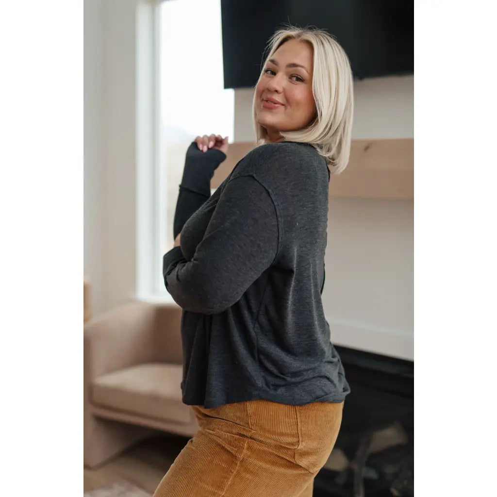 Cozy charcoal long sleeve top with thumb holes and v-neck. Relaxed fit available in plus sizes. Boutique comfy