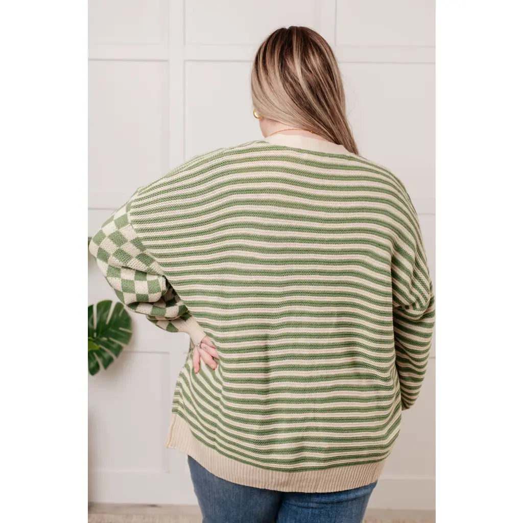 Stay cozy and stylish in our Check the Stripes Knit Cardigan Olive. This versatile piece features a flattering