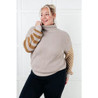 Stay warm in style with this Beige Turtleneck Sweater! Featuring a soft waffle knit and unique design caramel-hued