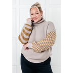 Stay warm in style with this Beige Turtleneck Sweater! Featuring a soft waffle knit and unique design caramel-hued