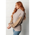 Stay warm in style with this Beige Turtleneck Sweater! Featuring a soft waffle knit and unique design caramel-hued