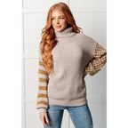 Stay warm in style with this Beige Turtleneck Sweater! Featuring a soft waffle knit and unique design caramel-hued