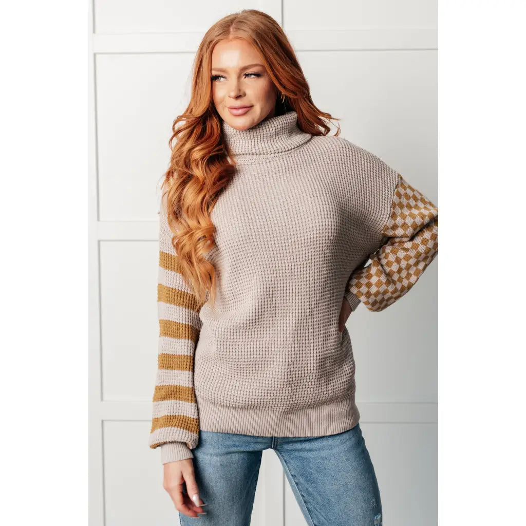 Stay warm in style with this Beige Turtleneck Sweater! Featuring a soft waffle knit and unique design caramel-hued
