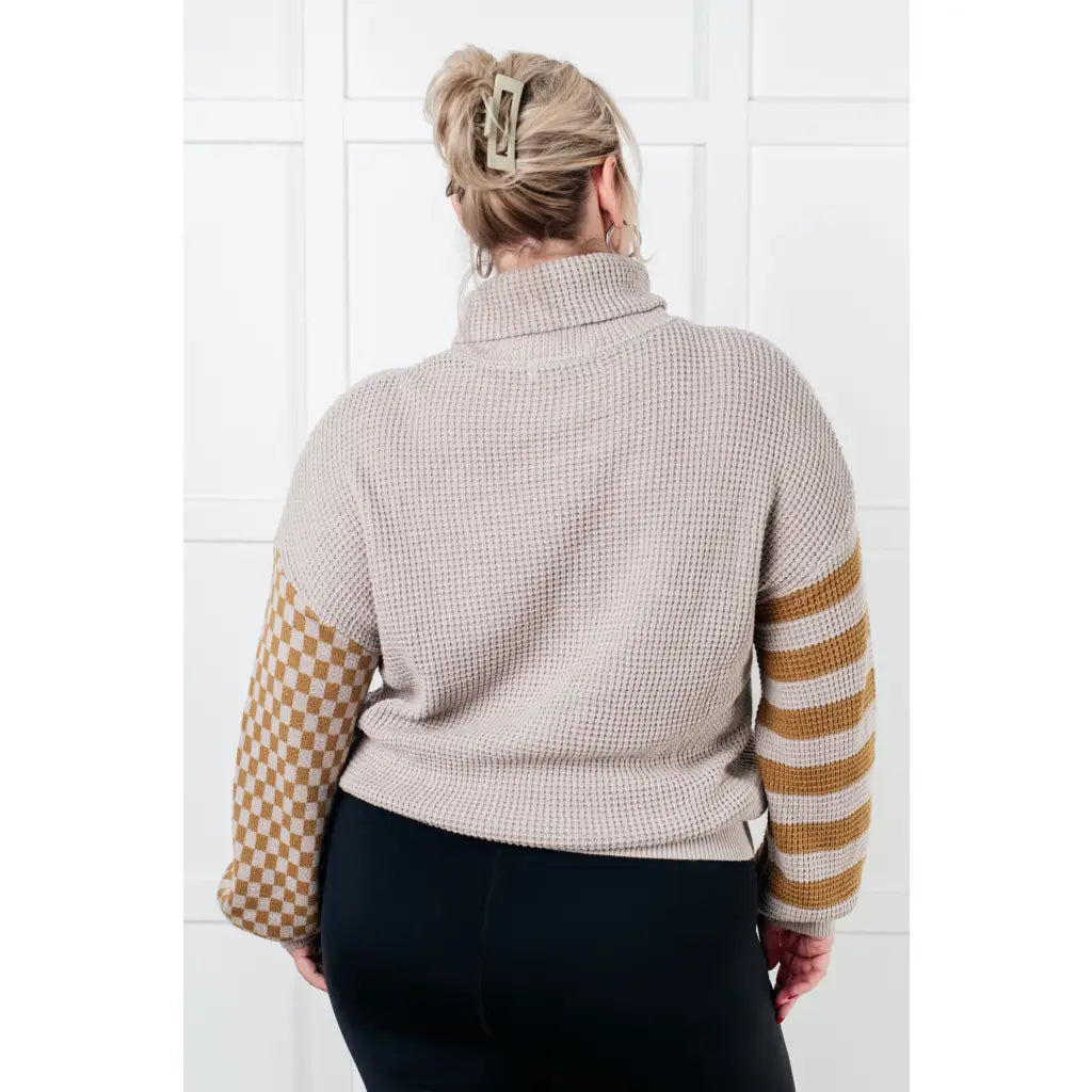 Stay warm in style with this Beige Turtleneck Sweater! Featuring a soft waffle knit and unique design caramel-hued