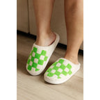 Step your way into comfort with these Checked Out Slippers in green and white. Crafted from a warm fuzzy looped French