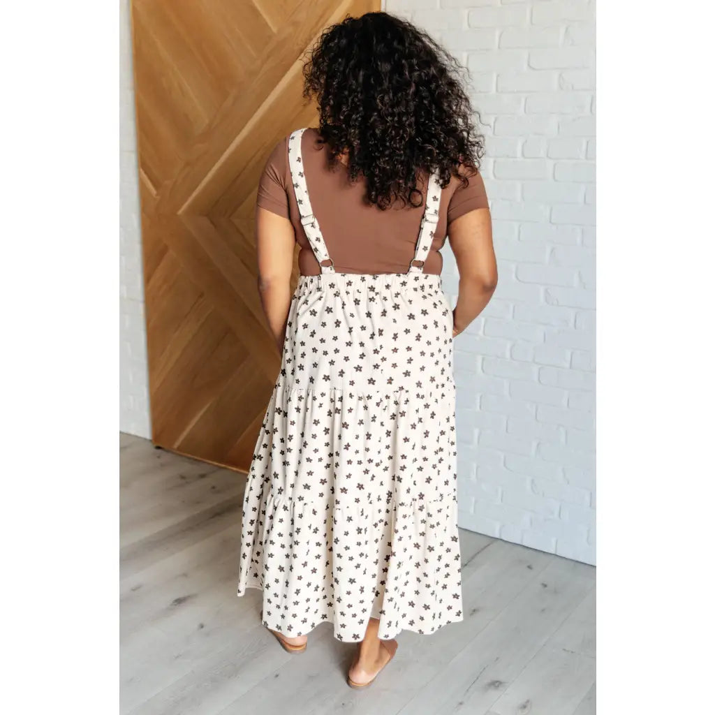 Shop this cream tiered maxi dress with soft corduroy texture and adjustable straps. Available in standard plus sizes