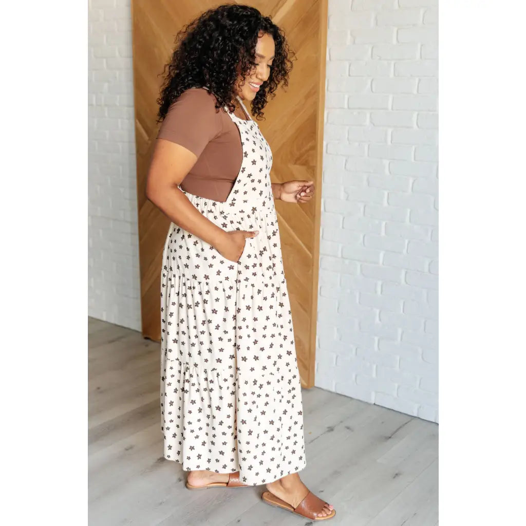 Shop this cream tiered maxi dress with soft corduroy texture and adjustable straps. Available in standard plus sizes