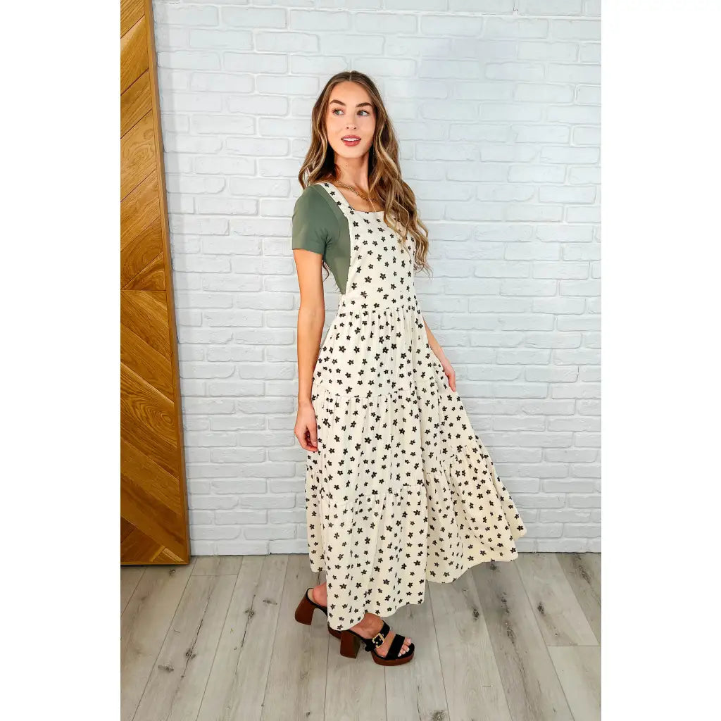 Shop this cream tiered maxi dress with soft corduroy texture and adjustable straps. Available in standard plus sizes