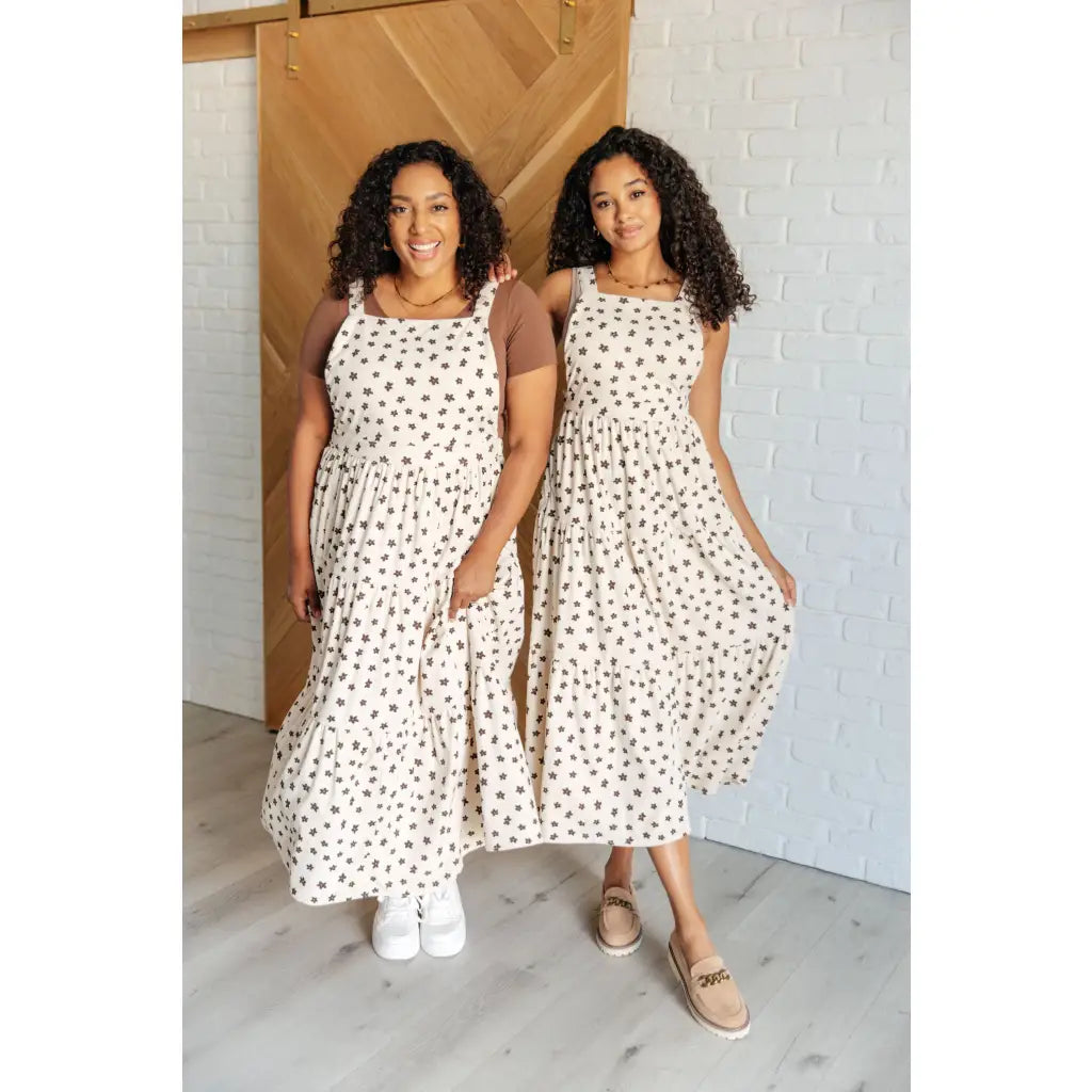 Shop this cream tiered maxi dress with soft corduroy texture and adjustable straps. Available in standard plus sizes