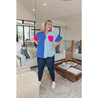 Stand out in the Color Pop Confidence Blouse! Bold color blocking a relaxed fit and luxe style — perfect top