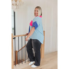 Stand out in the Color Pop Confidence Blouse! Bold color blocking a relaxed fit and luxe style — perfect top