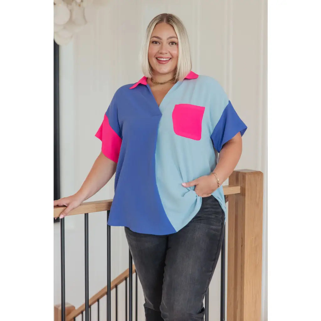 Stand out in the Color Pop Confidence Blouse! Bold color blocking a relaxed fit and luxe style — perfect top