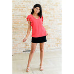 Shop our Coral Pink Ruffle Sleeve Top! Feminine flutter sleeves back tie detail and easy fit for everyday style.