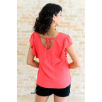 Shop our Coral Pink Ruffle Sleeve Top! Feminine flutter sleeves back tie detail and easy fit for everyday style.