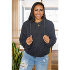 Our Cozy Does It Hoodie In Charcoal is so comfy! The coziness starts with a fuzzy medium weight knit that shapes slight