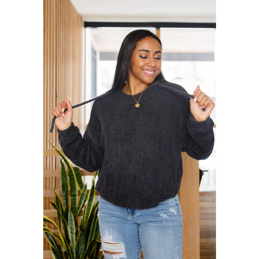Our Cozy Does It Hoodie In Charcoal is so comfy! The coziness starts with a fuzzy medium weight knit that shapes slight