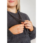 Our Cozy Does It Hoodie In Charcoal is so comfy! The coziness starts with a fuzzy medium weight knit that shapes slight