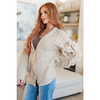 Fringe knit cardigan with button front and V-neckline. Plus sizes available. Cozy boutique layering piece playful