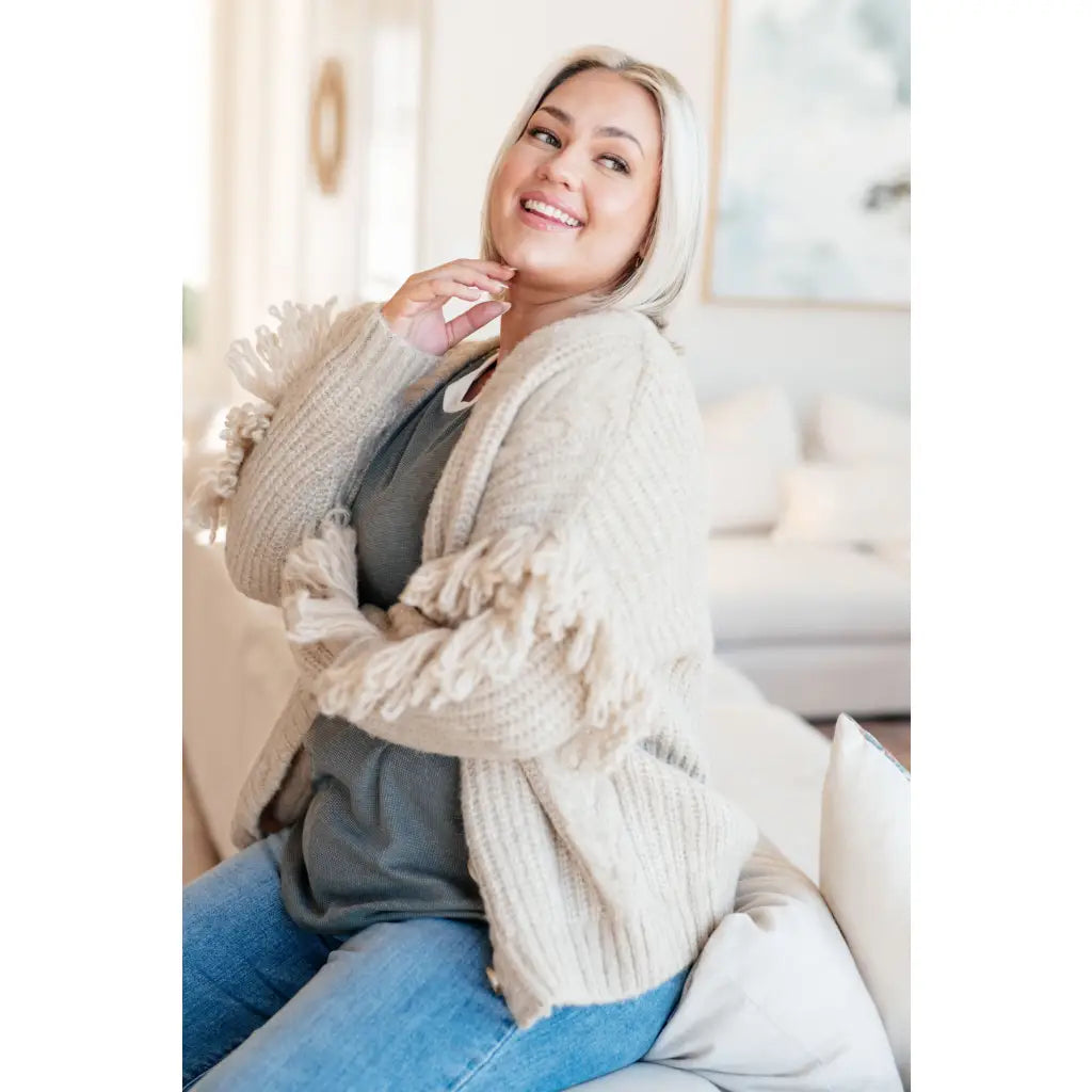 Fringe knit cardigan with button front and V-neckline. Plus sizes available. Cozy boutique layering piece playful
