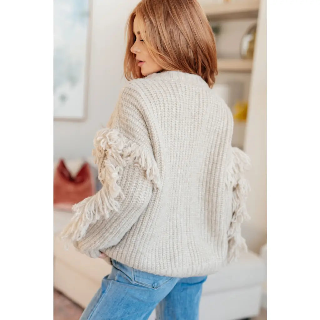 Fringe knit cardigan with button front and V-neckline. Plus sizes available. Cozy boutique layering piece playful