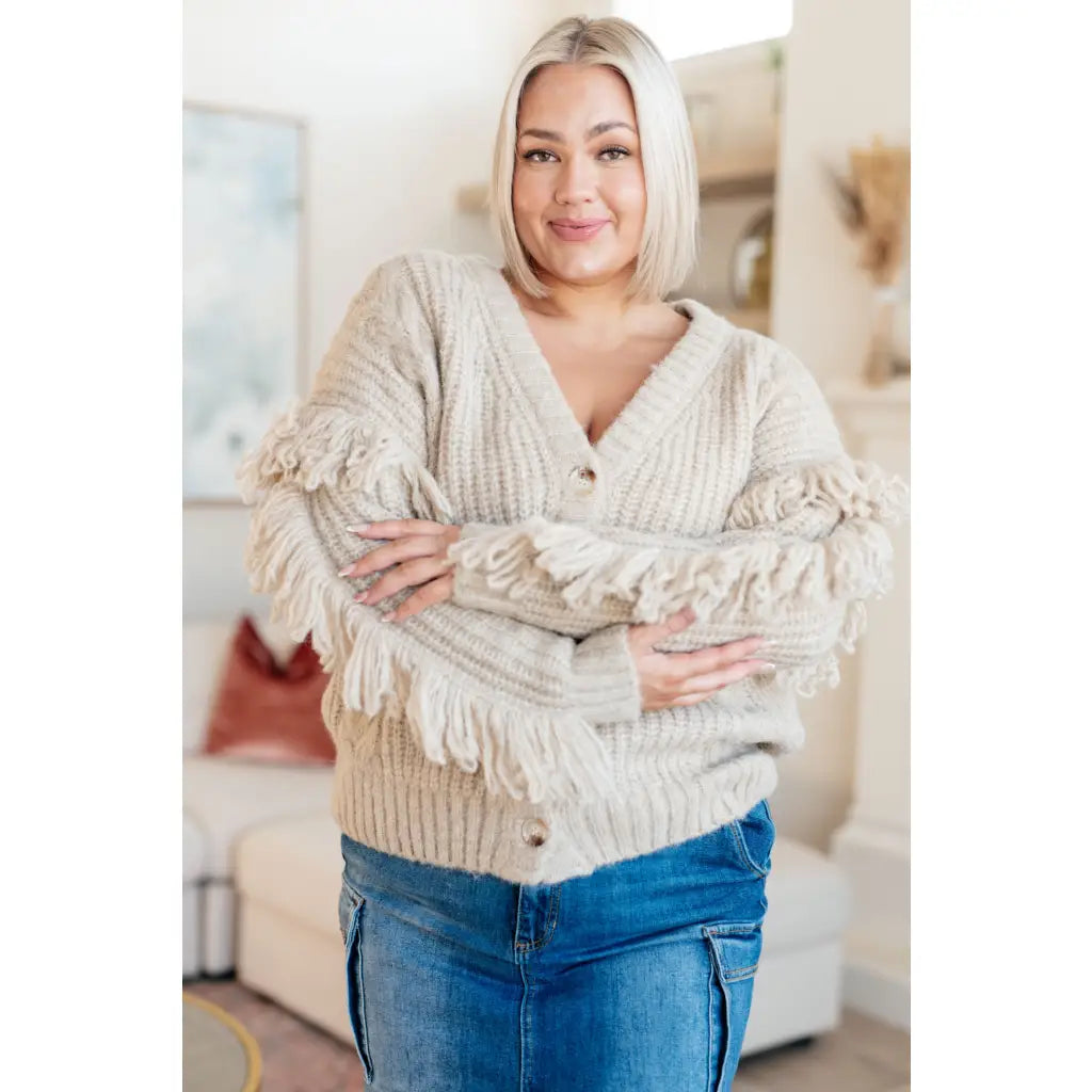 Fringe knit cardigan with button front and V-neckline. Plus sizes available. Cozy boutique layering piece playful