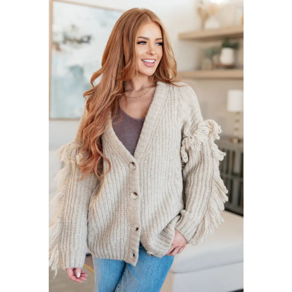 Fringe knit cardigan with button front and V-neckline. Plus sizes available. Cozy boutique layering piece playful