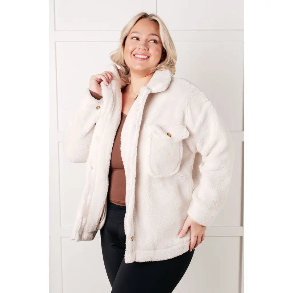 Stay cozy and chic with our Cuddly Sherpa Coat in Cream. Soft fleece jacket perfect for layering on chilly days.