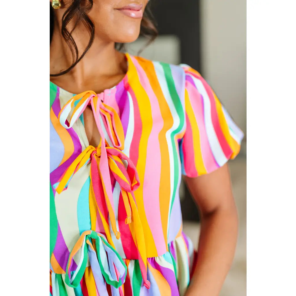 Bold swirl puff sleeve top in mint and orange. No-stretch woven fit with bows a gathered tier. Available regular plus