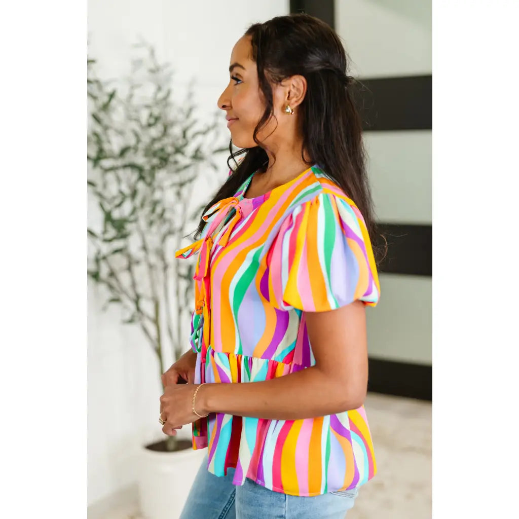 Bold swirl puff sleeve top in mint and orange. No-stretch woven fit with bows a gathered tier. Available regular plus