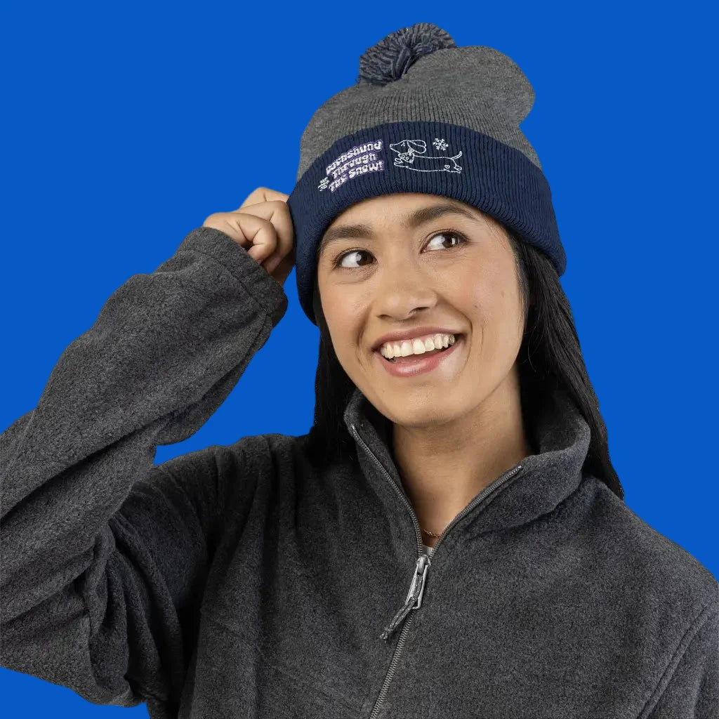 Cozy embroidered beanie with dachshund art by Sweet Roo Bou. A playful winter hat in six colors for dog lovers and fun