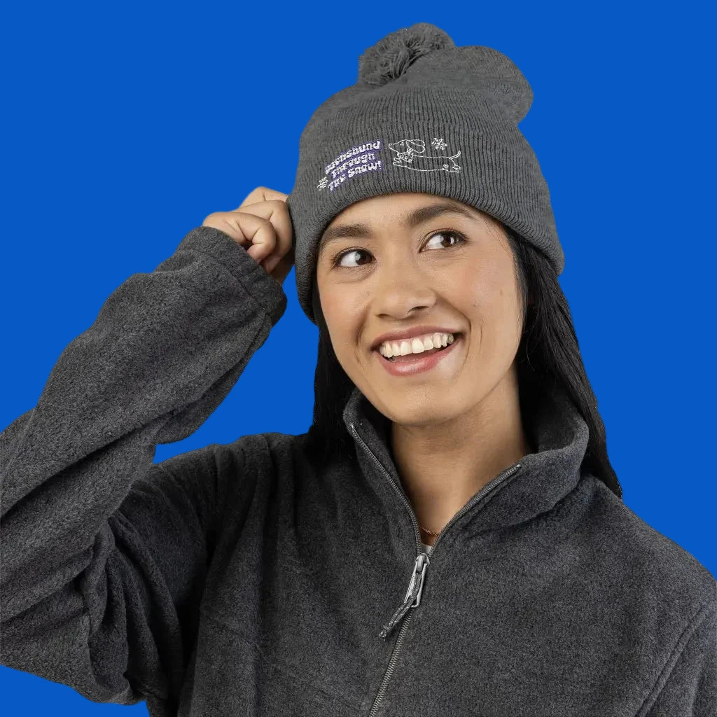 Cozy embroidered beanie with dachshund art by Sweet Roo Bou. A playful winter hat in six colors for dog lovers and fun