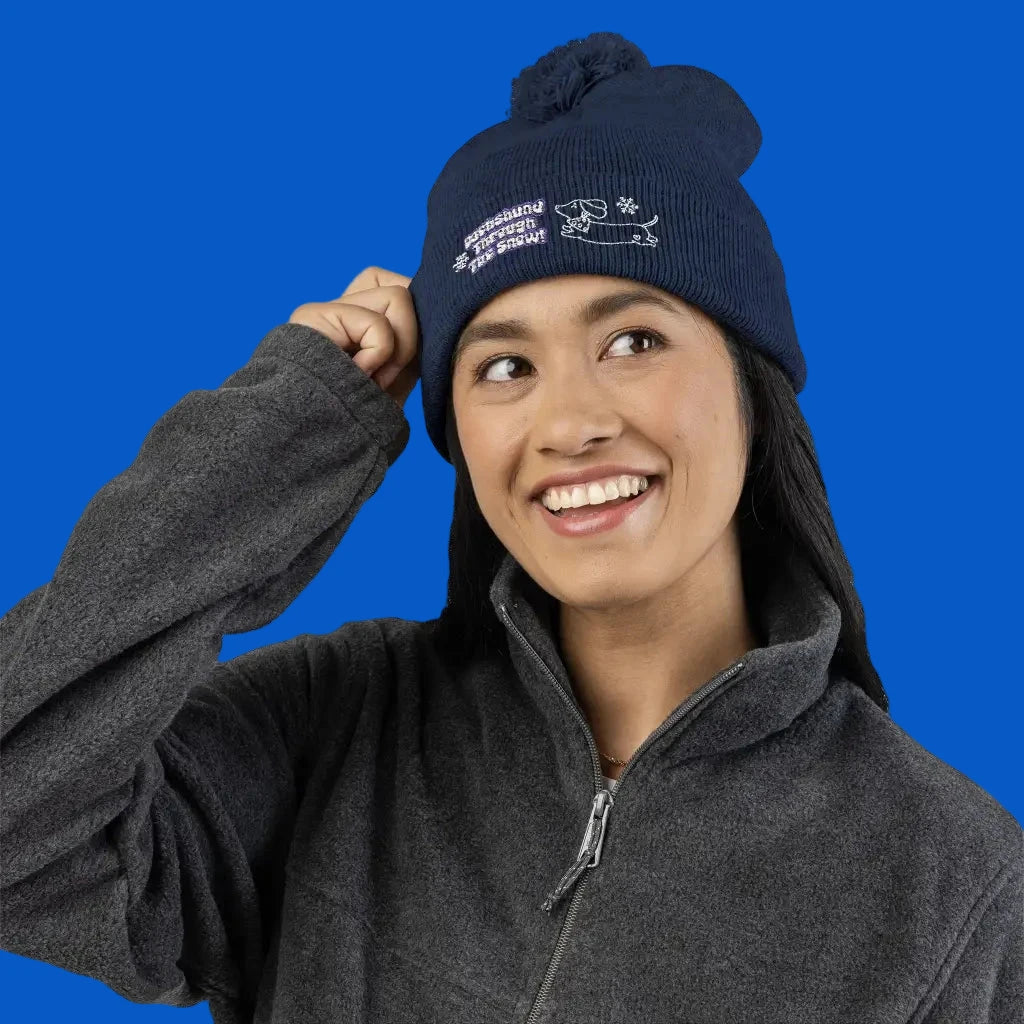 Cozy embroidered beanie with dachshund art by Sweet Roo Bou. A playful winter hat in six colors for dog lovers and fun