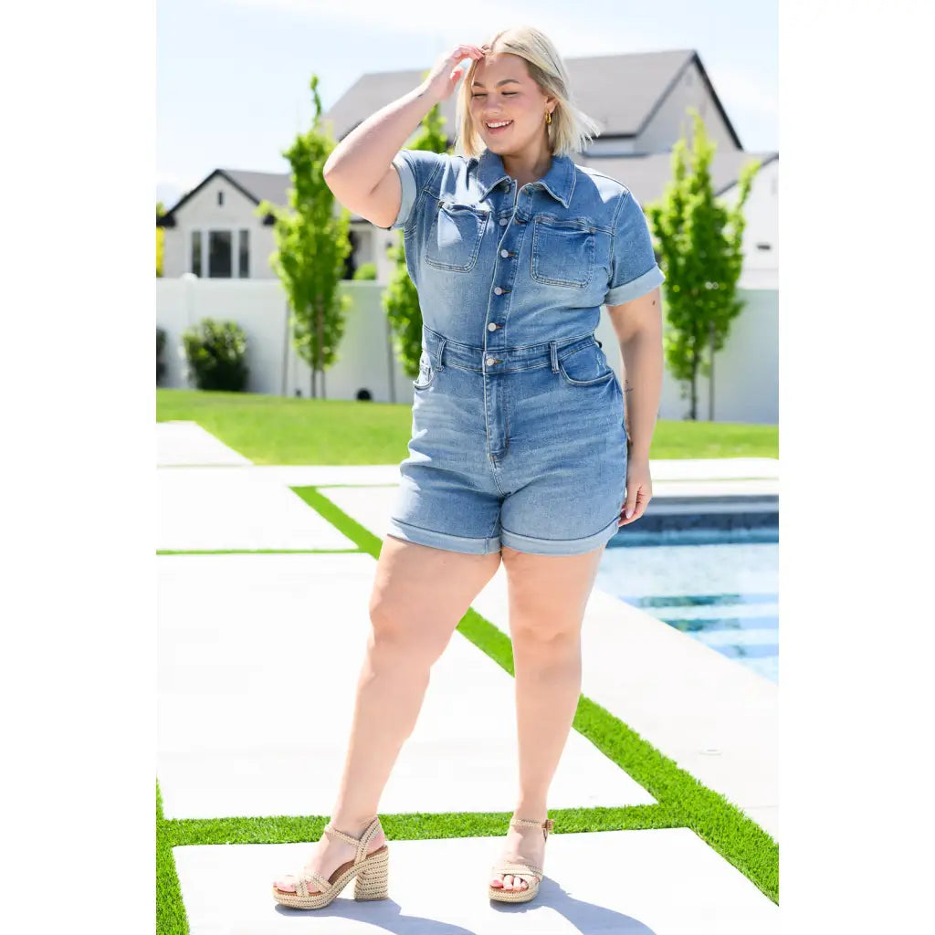 Unleash your playful side with our Delia Judy Blue Denim Romper. This 4 way stretchy jean romper features a button