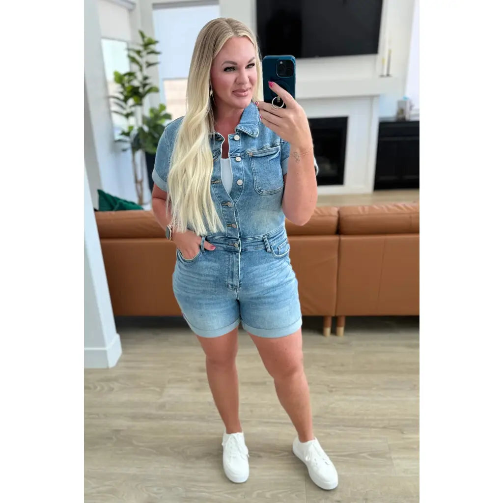 Unleash your playful side with our Delia Judy Blue Denim Romper. This 4 way stretchy jean romper features a button