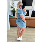 Unleash your playful side with our Delia Judy Blue Denim Romper. This 4-way stretchy jean romper features a button