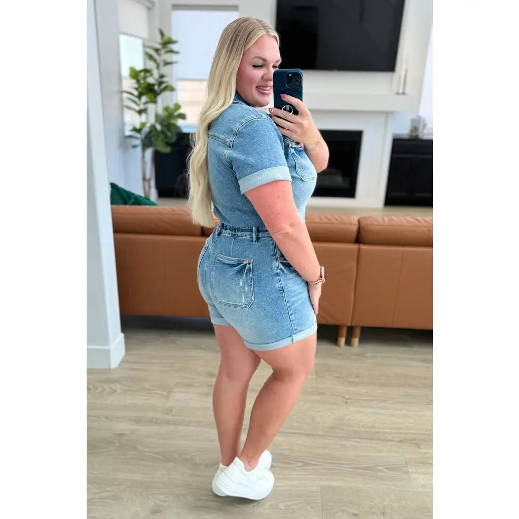 Unleash your playful side with our Delia Judy Blue Denim Romper. This 4-way stretchy jean romper features a button