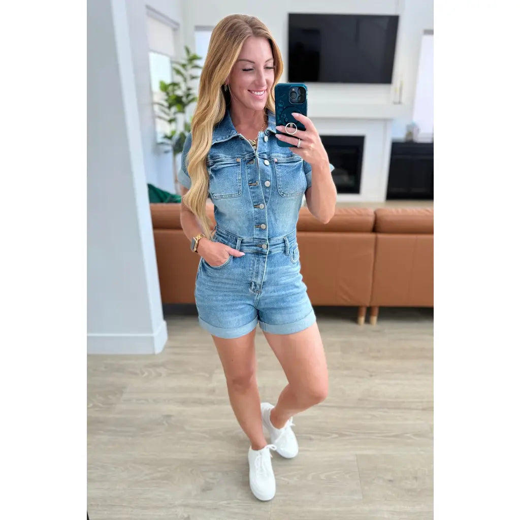 Unleash your playful side with our Delia Judy Blue Denim Romper. This 4 way stretchy jean romper features a button