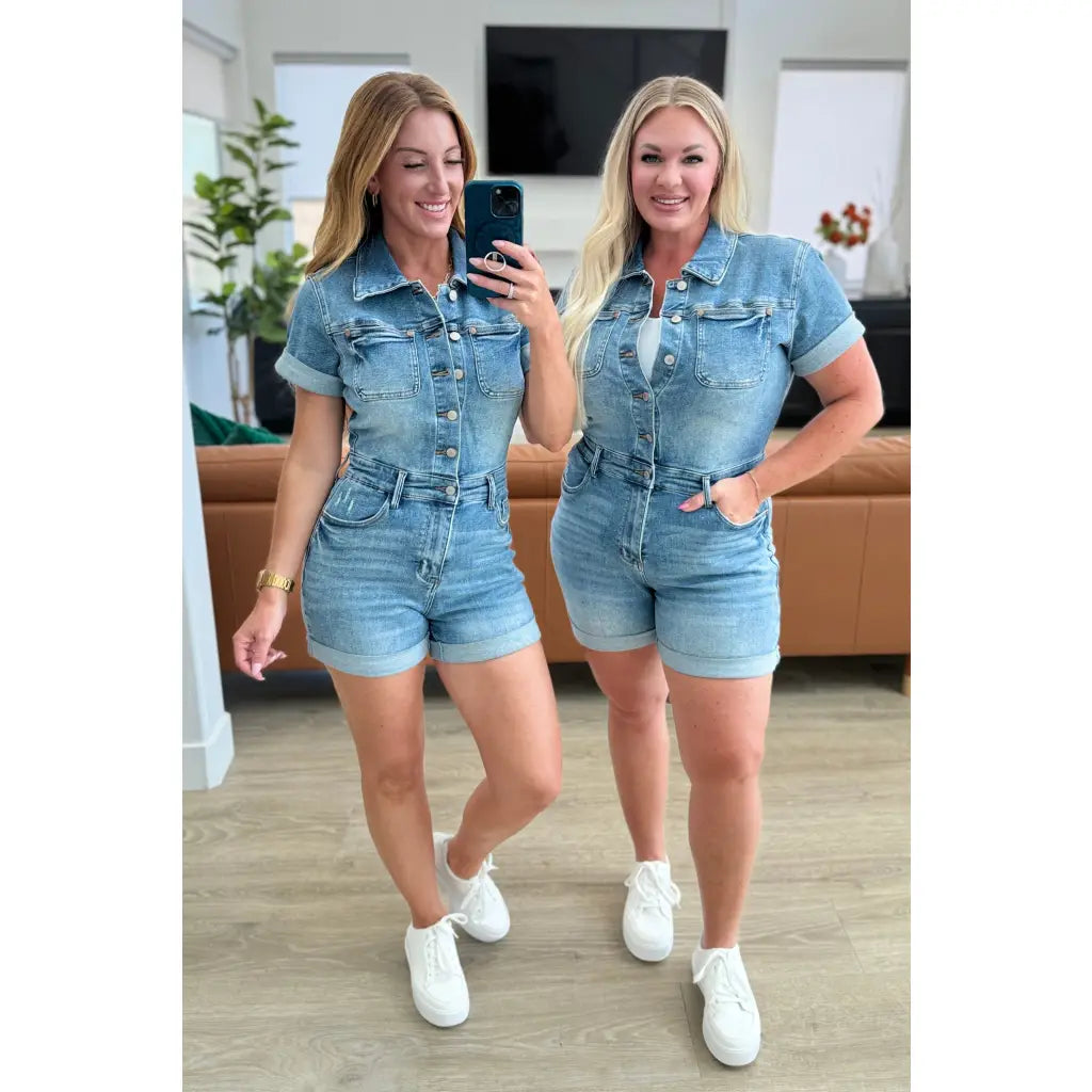 Unleash your playful side with our Delia Judy Blue Denim Romper. This 4-way stretchy jean romper features a button