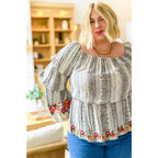 Fashioned with bold snake print and exquisite floral embroidery our Don’t Tempt Me Blouse delivers an irresistible