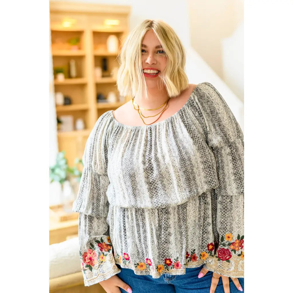 Fashioned with bold snake print and exquisite floral embroidery our Don’t Tempt Me Blouse delivers an irresistible