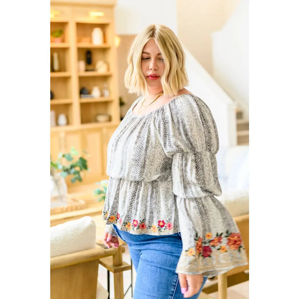 Fashioned with bold snake print and exquisite floral embroidery our Don’t Tempt Me Blouse delivers an irresistible