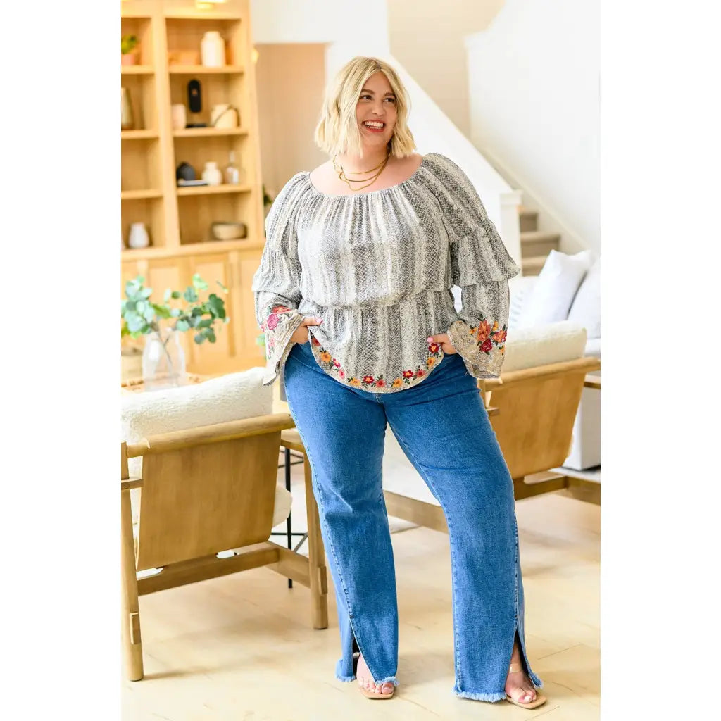 Fashioned with bold snake print and exquisite floral embroidery our Don’t Tempt Me Blouse delivers an irresistible