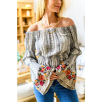 Fashioned with bold snake print and exquisite floral embroidery our Don’t Tempt Me Blouse delivers an irresistible