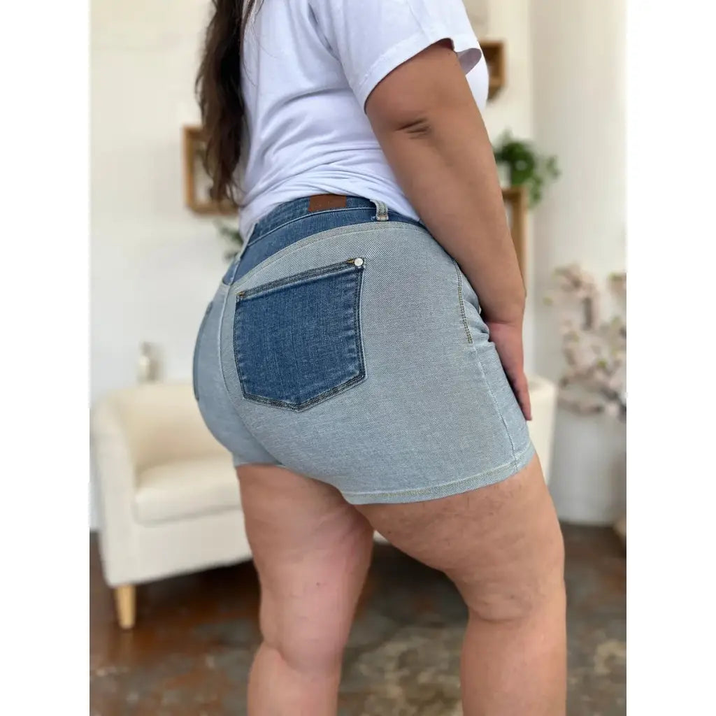 Two-tone Judy Blue denim shorts with color block detail and curve-hugging stretch. Plus size friendly perfect for bold