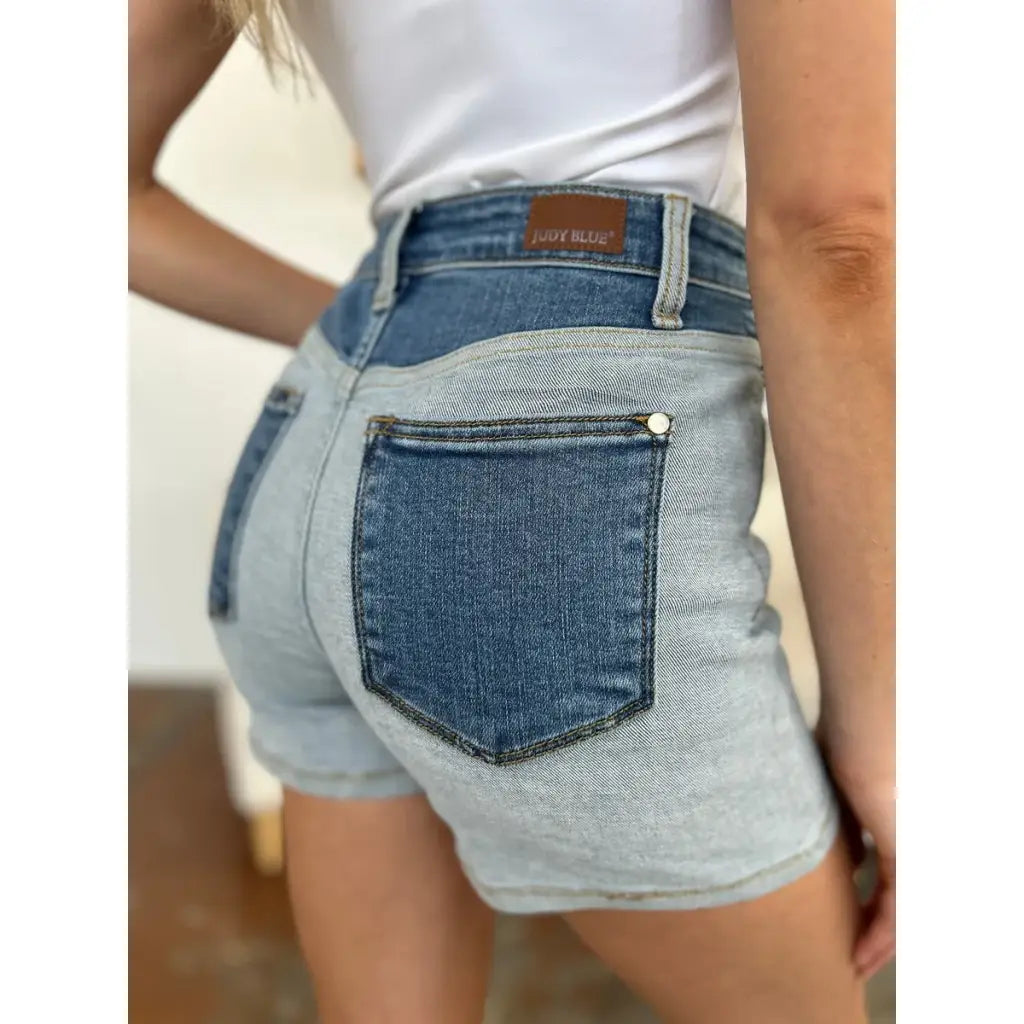 Two-tone Judy Blue denim shorts with color block detail and curve-hugging stretch. Plus size friendly perfect for bold