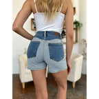 Two-tone Judy Blue denim shorts with color block detail and curve-hugging stretch. Plus size friendly perfect for bold