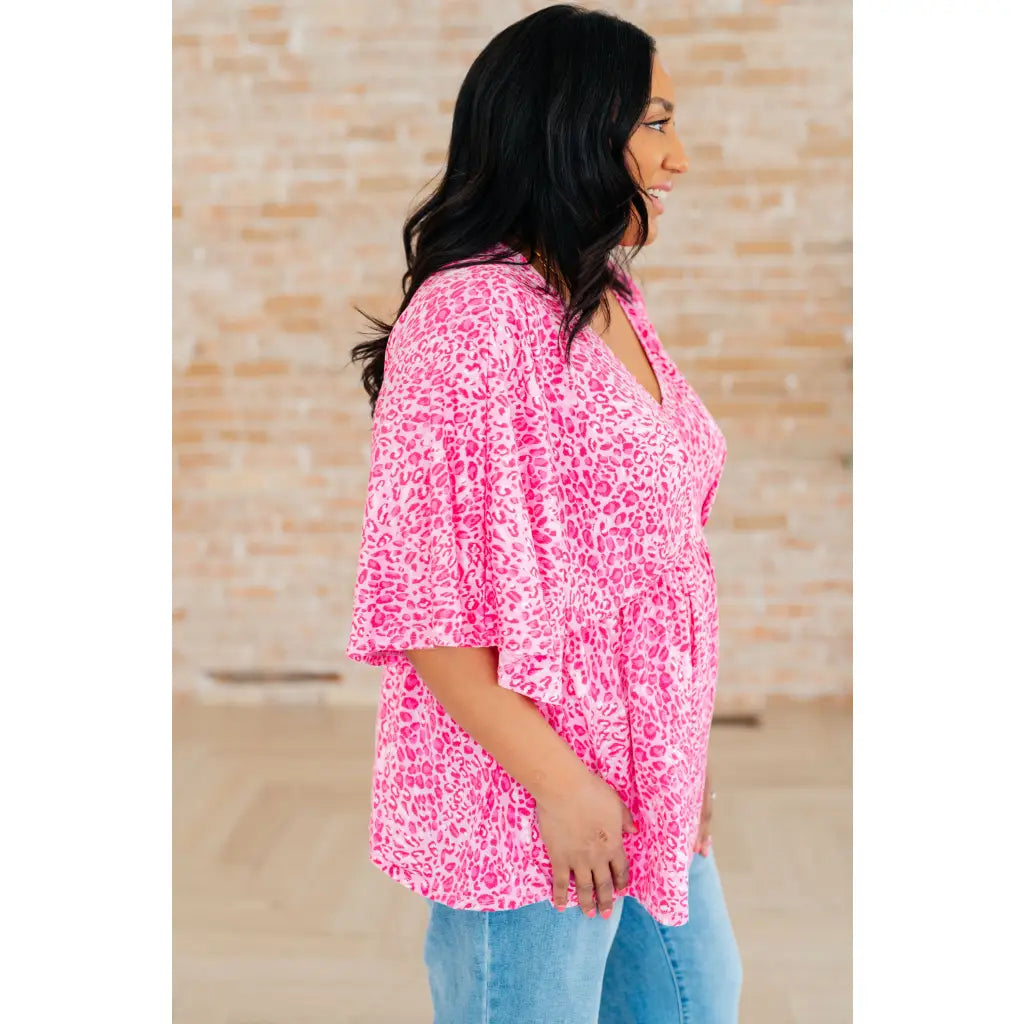 Step out in our Dreamer Peplum Top Pink Leopard! Featuring a playful v neckline flowy dolman sleeves and flattering