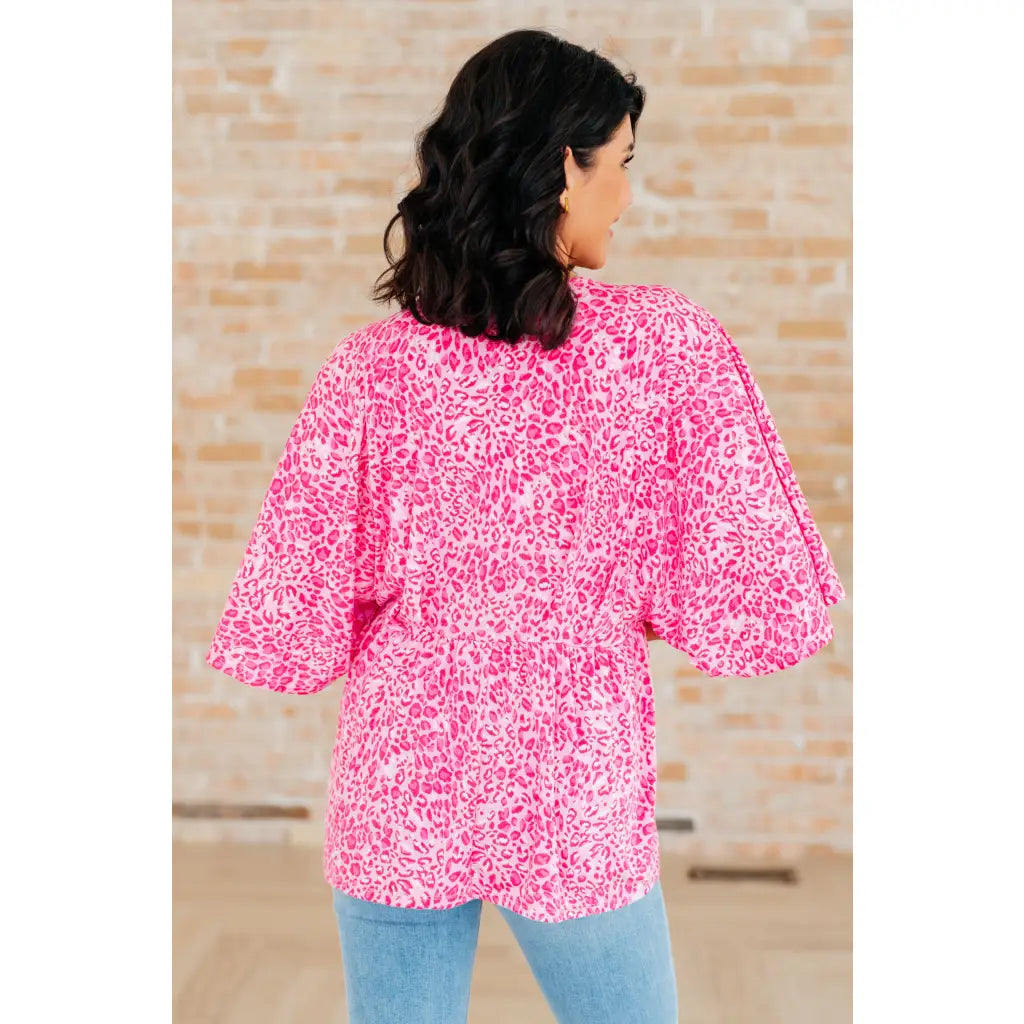 Step out in our Dreamer Peplum Top Pink Leopard! Featuring a playful v - neckline flowy dolman sleeves and flattering
