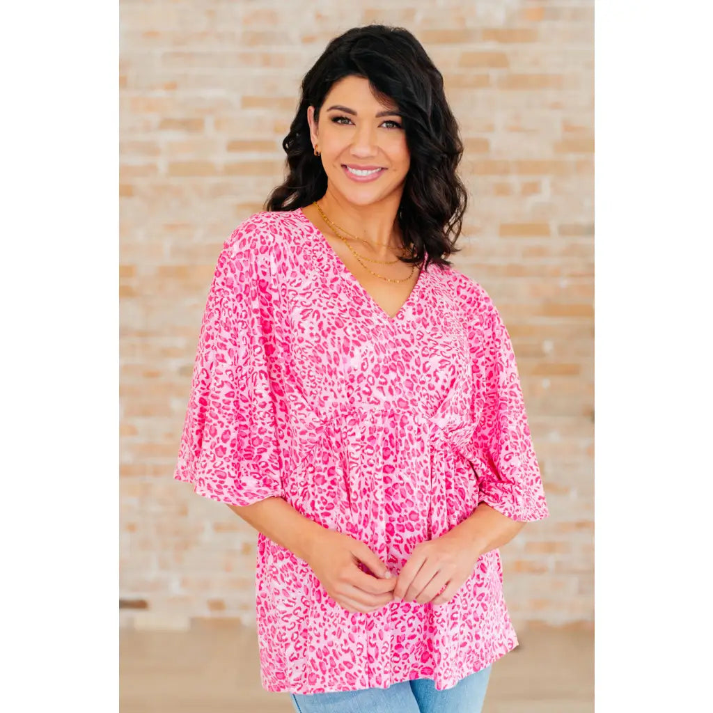Step out in our Dreamer Peplum Top Pink Leopard! Featuring a playful v neckline flowy dolman sleeves and flattering