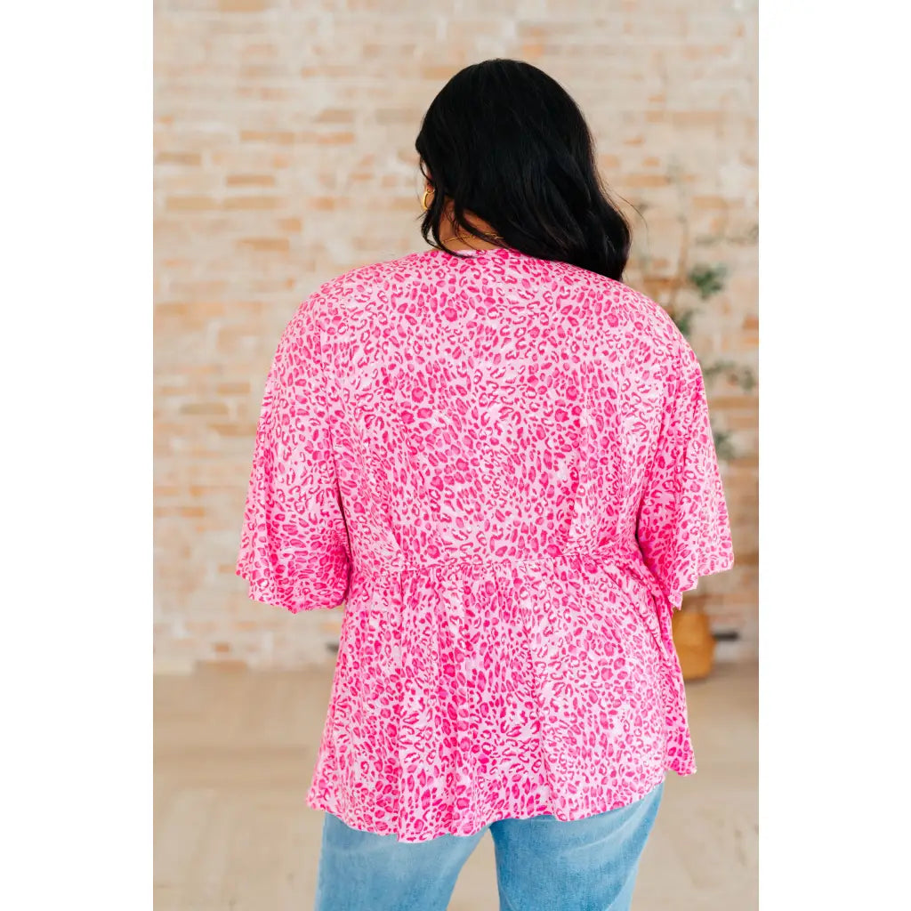 Step out in our Dreamer Peplum Top Pink Leopard! Featuring a playful v neckline flowy dolman sleeves and flattering